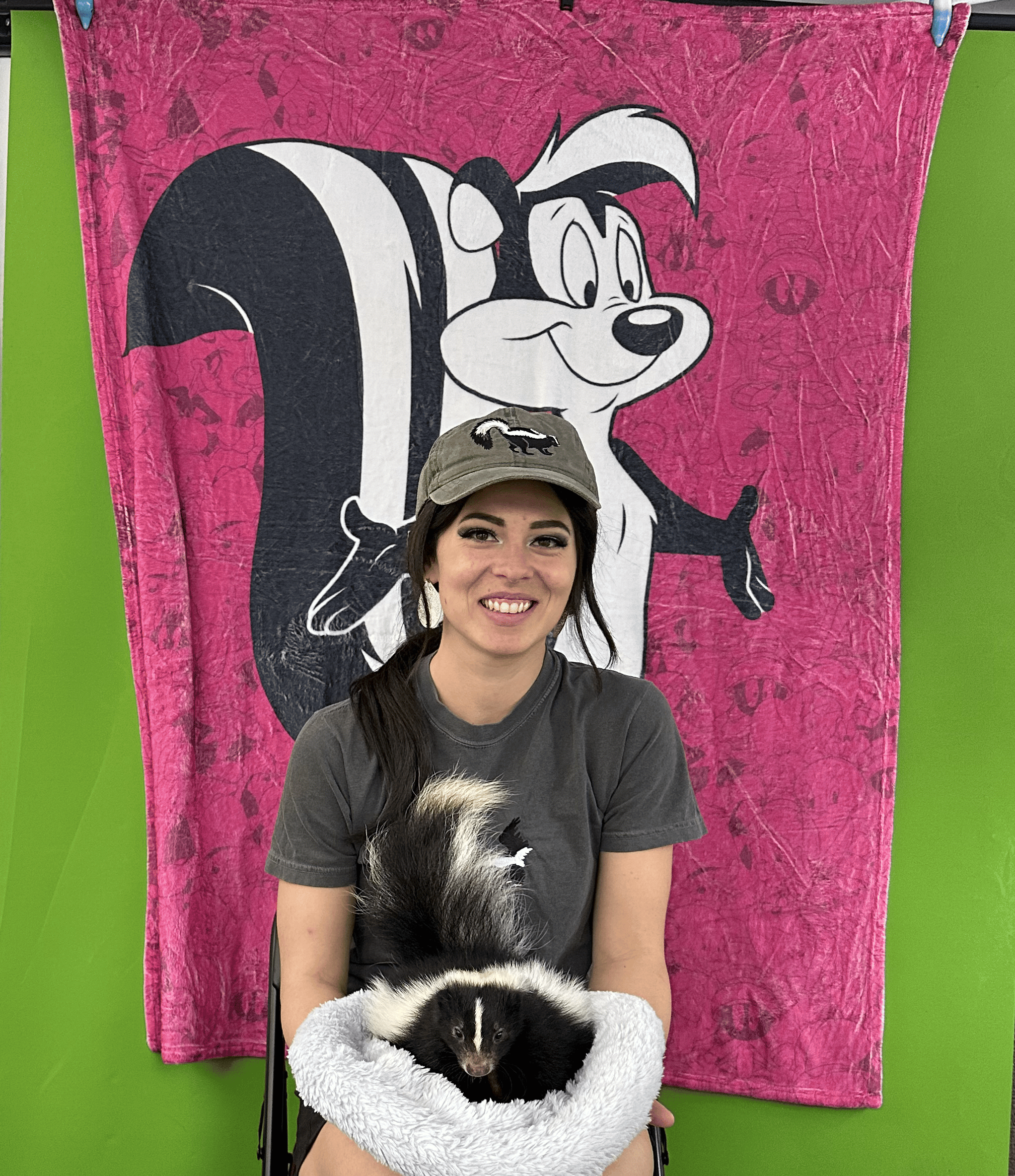 Church member wearing skunk-themed hat